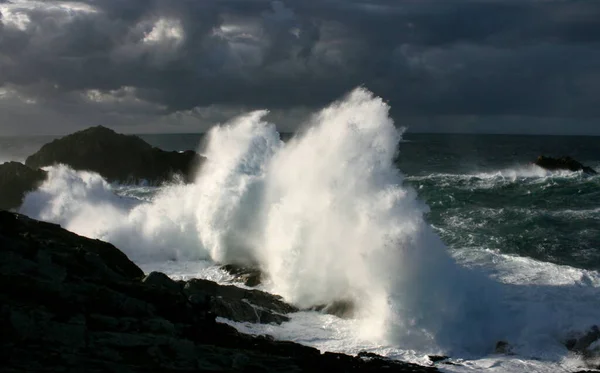 Giant waves breaking on the shore, cape A Frouxeira, A Coruna, Galicia, Spain, temporary sea coast, storm at sea, cliffs, foam, ocean, clouds,