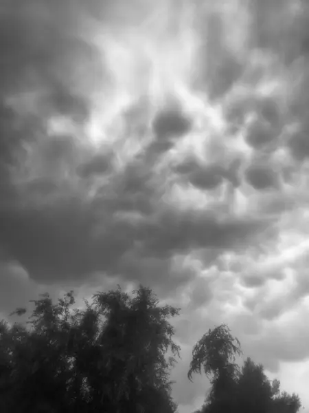 stock image mamatus clouds, allegory of bad omen, bad feeling, suspicion,fear, photography storm clouds, visual allegories, visual metaphors, diffuser filter,