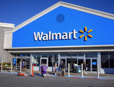 Walmart customers exit the popular retailer after shopping, Lynn Massachusetts USA, October 15 2022 clipart