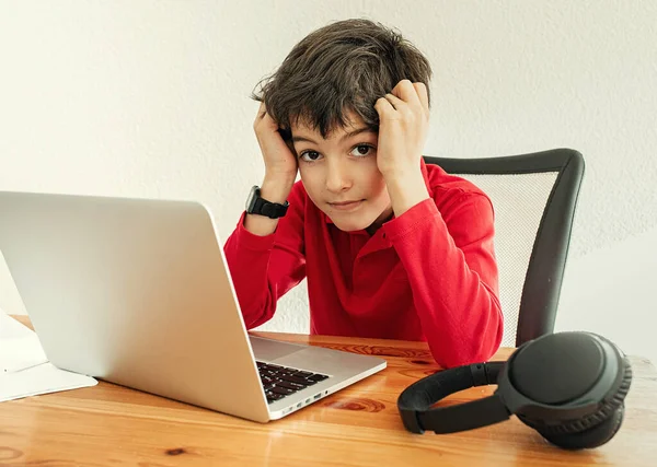 Little school boy stressed of online learning. Boy learning online class room at home, E-learning or Homeschooling education concept