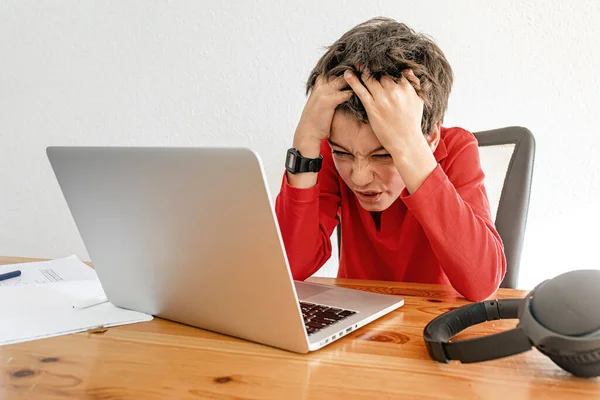 Little school boy stressed of online learning. Boy learning online class room at home, E-learning or Homeschooling education concept
