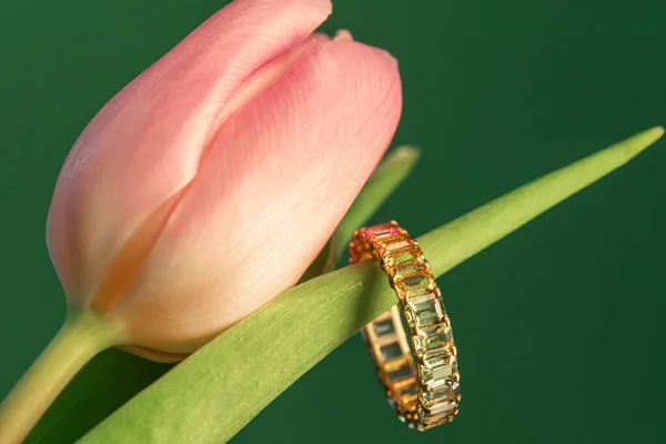 Jewelry, rings and earrings with precious stones. Spring concept. Rings and earrings on tulips.