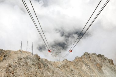 Alpler 'de teleferik ve turist kulübesi. Karlı dağ zirveleri ve manzarası. İsviçre Alpleri