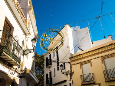 Typical narrow street in the Spanish resort of Nerja on the Costa Del Sol. There are no skyscraper hotels or apartments allowed in the town so it has retained its old world charm and is a delight to wander