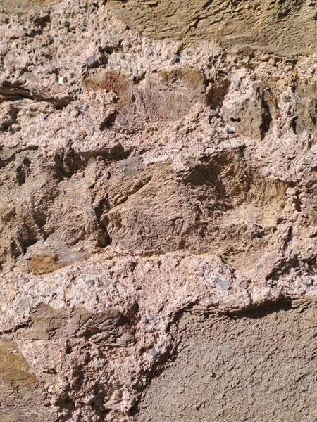 Çatlakları ve çizikleri olan taş bir duvarın dokusu arka plan olarak kullanılabilir.