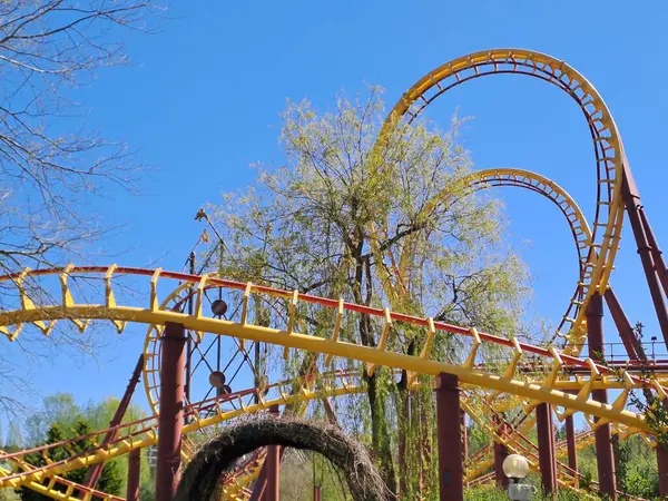 Mavi gökyüzü olan sarı ve kırmızı bir hız treninin yüksek açılı görüntüsü.