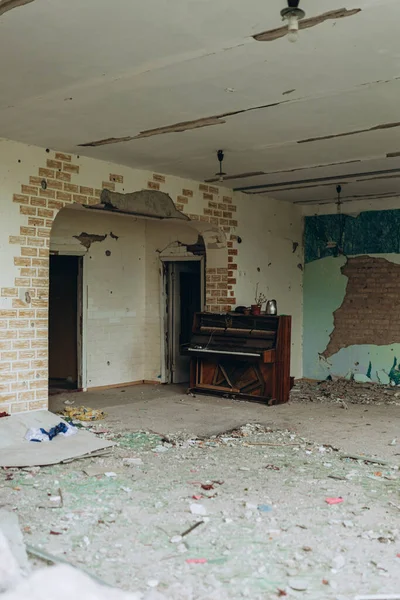 stock image Bilozirka, Ukraine - March 26, 2023: War of Russia against Ukraine. Damaged and destroyed kindergarten in village after bomb explosions between floors. Damaged Piano in musical class in the building. 