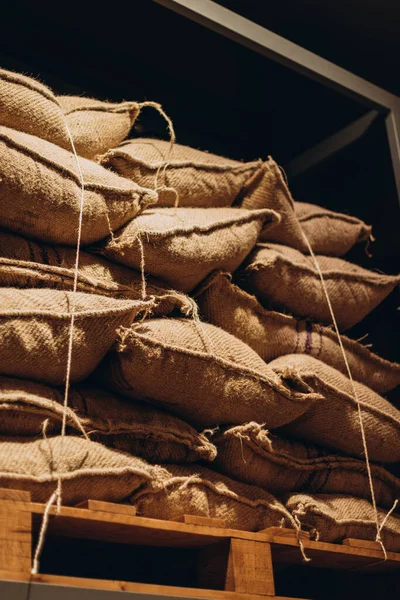 stock image Villajoyosa, Spain - May 16, 2023: Pile of sacks of cocoa at exhibition at the excursion hall in chocolate factory 