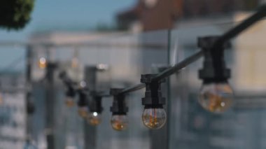 Parti dekorasyonu, retro çelenk. Kafede yuvarlak ampullü elektrik lambası çelenkleri asılı..