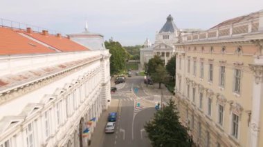 Aerial video in Arad city center shot from a drone while flying forward at a lower altitude between the buildings towards the Cultural Palace in Arad, Romania.