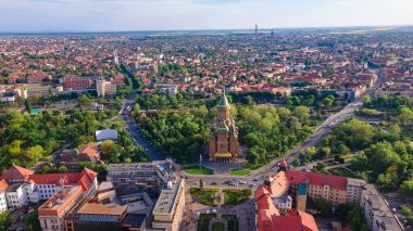 Aerial view of the beautiful city of Timisoara, Romania. Photography was shot from a drone at a higher altitude with the Mitropolitan Cathedral and the parks in the view. clipart