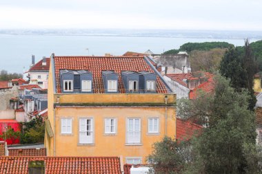Lizbon, Portekiz 'de daireleri olan tarihi bir evin dış cephesi. Tagus Nehri manzarası. Alfama bölgesi. Kentsel vintage arkaplan.