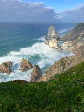 Portekiz 'in Atlantik Okyanusu kıyısındaki Cape of Rock (Cabo da Roca) kayalıkları rüzgar, dalgalar ve su sıçramalarıyla dolu. Praia da Ursa plajı. Avrupa 'nın en batı noktası..