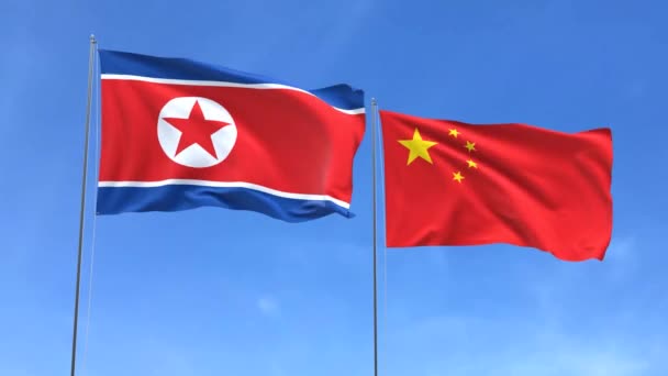 Acenando Bandeiras Coreia Norte China Fundo Céu Azul — Vídeo de Stock