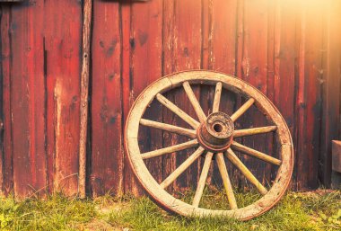 Eski paslı araba tekerleği ahıra yaslanıyor. Köylü aleti. Yüksek kalite fotoğraf