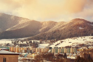 View of a town in winter season.Beautiful snowy mountains in background. High quality photo