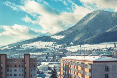 View of a town in winter season.Beautiful snowy mountains in background. High quality photo