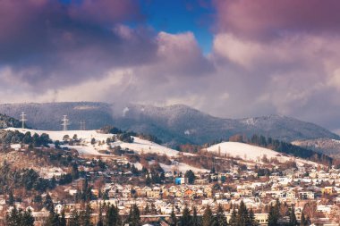 View of a town in winter season.Beautiful snowy mountains in background. High quality photo