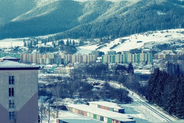 View of a town in winter season.Beautiful snowy mountains in background. High quality photo