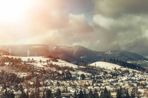 View of a town in winter season.Beautiful snowy mountains in background. High quality photo