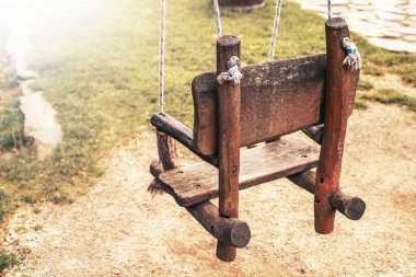 Empty wooden swing in a park. High quality photo