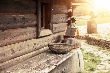 Side view of a log house and old peasant tools. High quality photo
