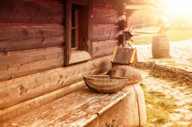 Side view of a log house and old peasant tools. High quality photo
