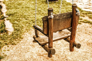 Empty wooden swing in a park. High quality photo