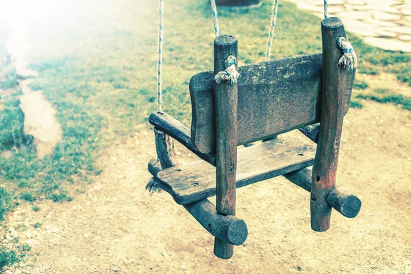 Empty wooden swing in a park. High quality photo