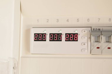 Apartmanın duvarındaki santralde gelen voltaj ve arta kalan akım aygıtlarını gösteren voltaj rölesi