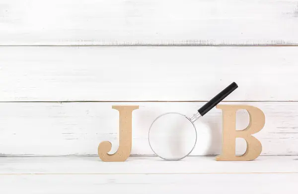 stock image Wooden Letters 'JOB' with Magnifying Glass on White Wooden Background Symbolizing Job Search and Employment Focus