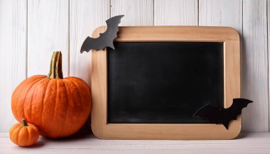 Halloween Pumpkins with Bats and Blank Chalkboard for Festive Decorations clipart