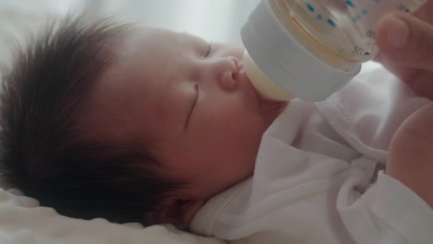 Mother Feeding Her Daughter Child Milk Baby Bottle Home — Vídeo de Stock