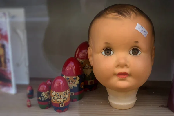 Closeup of vintage head of doll in a toys store showroom