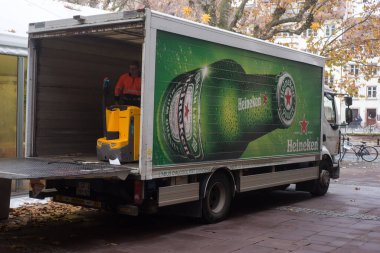 Strasbourg - Fransa - 2 Aralık 2022 - Heineken mallarını restoranın yakınına park etmiş içki kamyonundan boşaltan teslimatçı