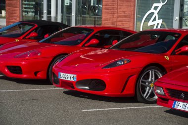 Lutterbach - France - 4 September 2022 -  Front view of red ferrari cars alignment parked in the street