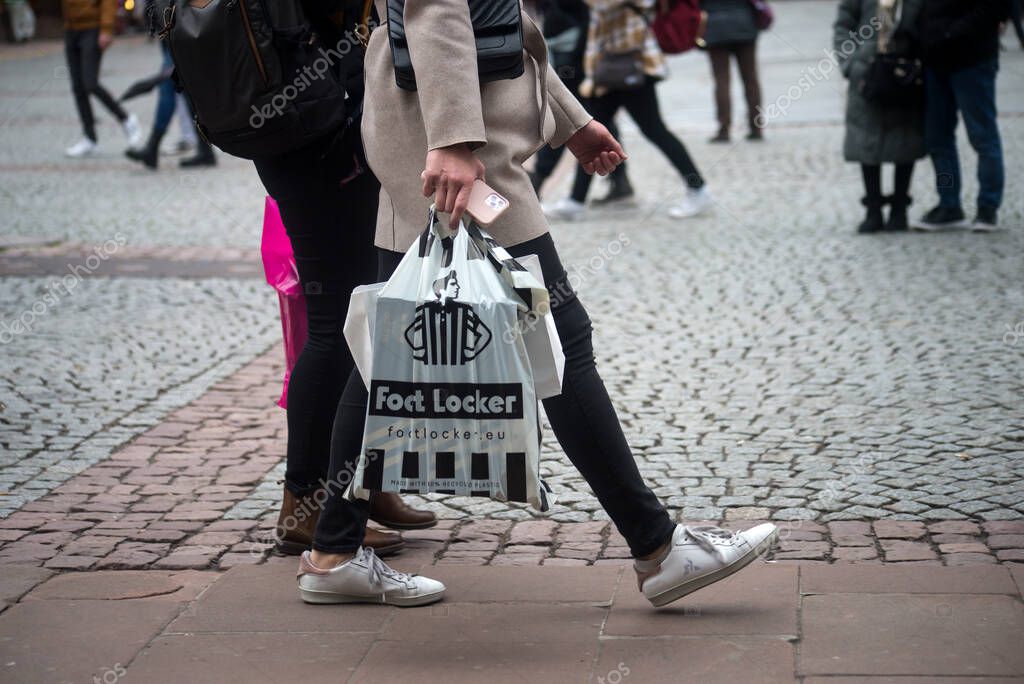 Strasbourg - France - 16 January 2023 - Closeup of woman with a foot locker paper bag in the street