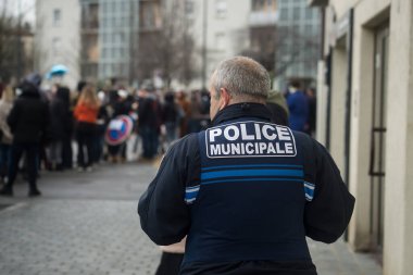 Riedisheim  - France - 6 February 2023 - Portrait on back view of french police man standing in the street