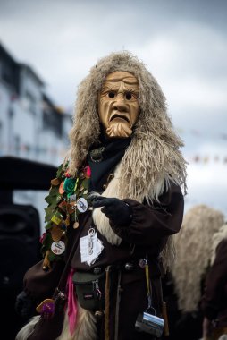 Neuenburg - Germany - 19 February 2023 - portrait of masked people wearing traditional costume parading in the street