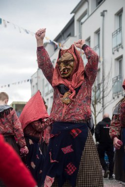Neuenburg - Germany - 19 February 2023 -  portrait of people with wooden mask parading in the street