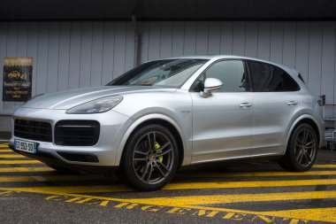 Mulhouse - Fransa - 11 Mart 2023 - Yağmurlu bir günde sokağa park edilmiş gri Porsche Cayenne manzarası