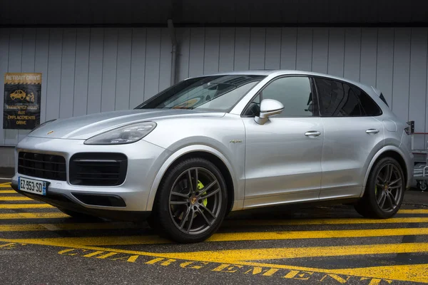 stock image Mulhouse - France - 11 March 2023 - Front view of grey Porsche cayenne parked in the street by rainy day