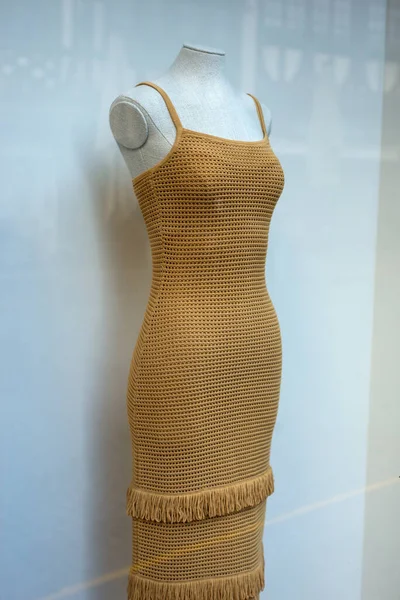 Closeup of brown dress on mannequin in a fashion store showroom