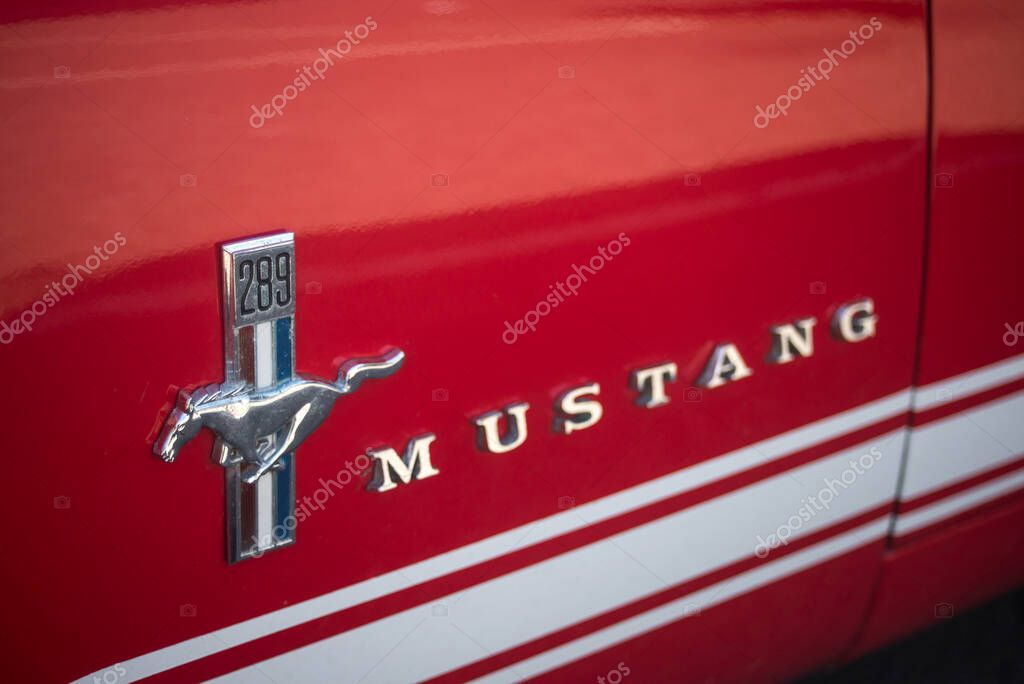 Mulhouse - France - 9 July 2023 - Closeup of logo on red ford mustang door parked in the street