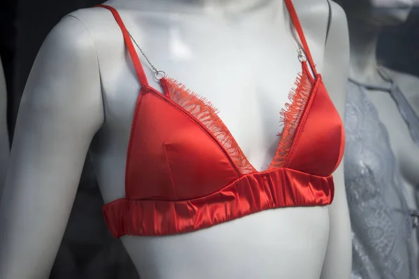 Closeup of orange bra on mannequin in a fashion store showroom