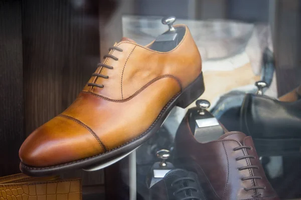 Closeup of brown leather shoes for men in a luxury fashion store showroom