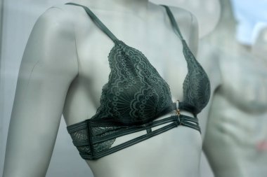 Moda mağazasının vitrininde manken üzerine yeşil sütyen.