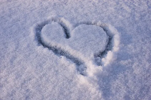 Closeup of heart drawing in the snow