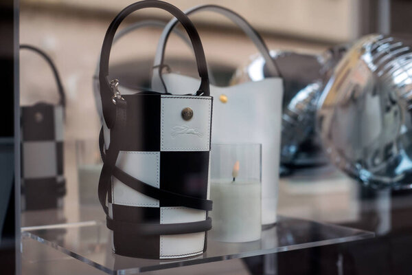 Closeup of black and white leather hand bag in a luxury fashion tote showroom