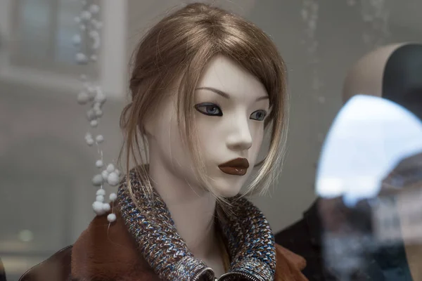 Closeup of blond hair mannequin in a women fashion store showroom